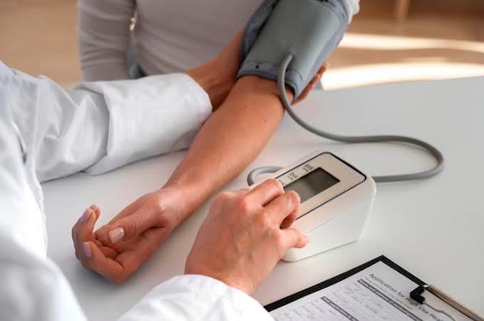 Blood pressure check during a medical consultation for hypertension and preventive healthcare at B Healthy Clinic.